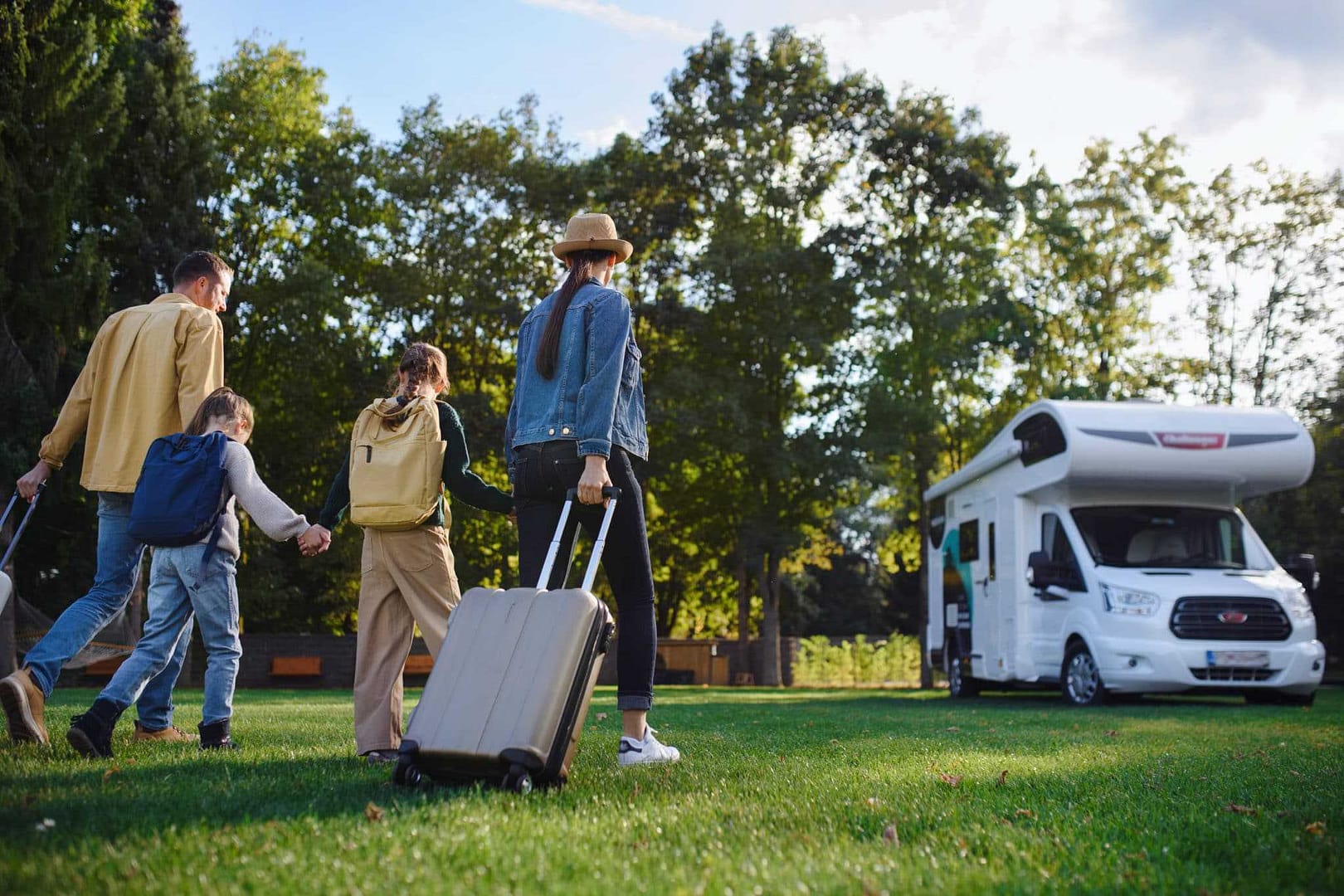 Increase: A family is walking with luggage in front of an rv, suggesting a growing interest in caravans.