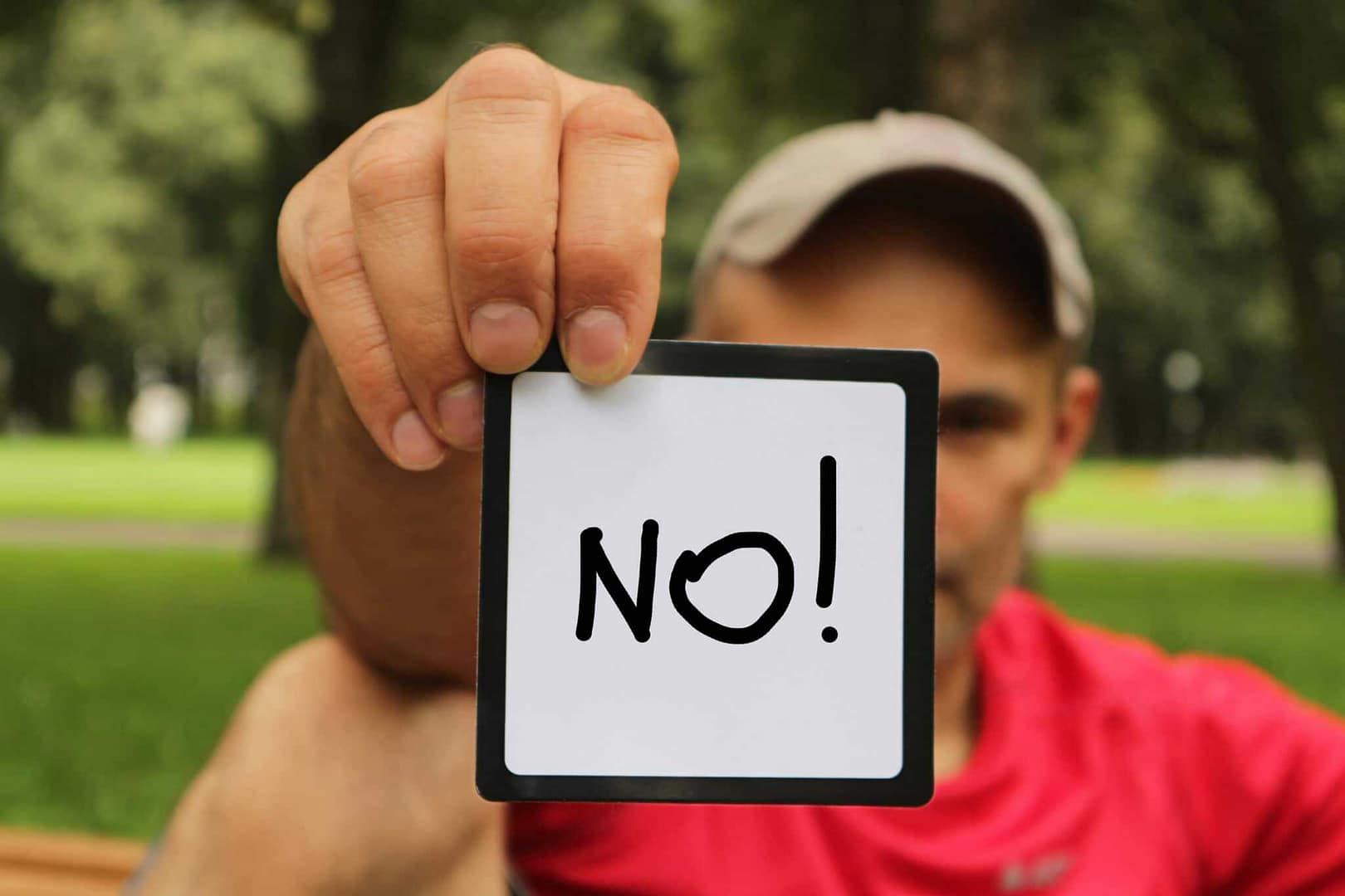 A man holding up a sign that says "no" in protest against the rejected rezoning plan for the RV Resort.