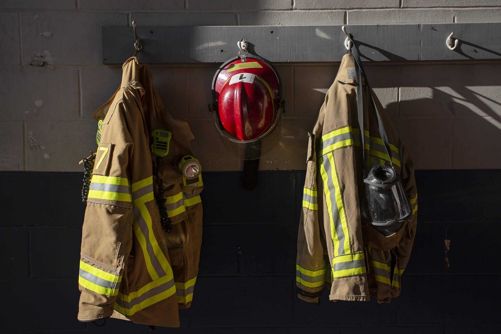 A firefighter's jacket and helmet hanging on a wall in Idaho.