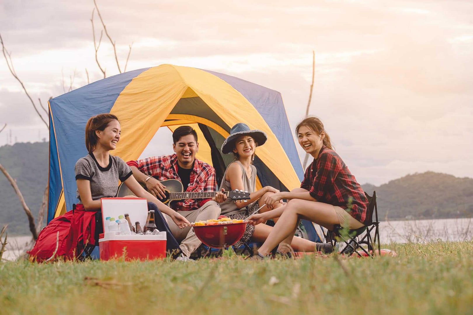 Neath Port Talbot officials and locals enjoying a camping excursion in a picturesque tent setting.