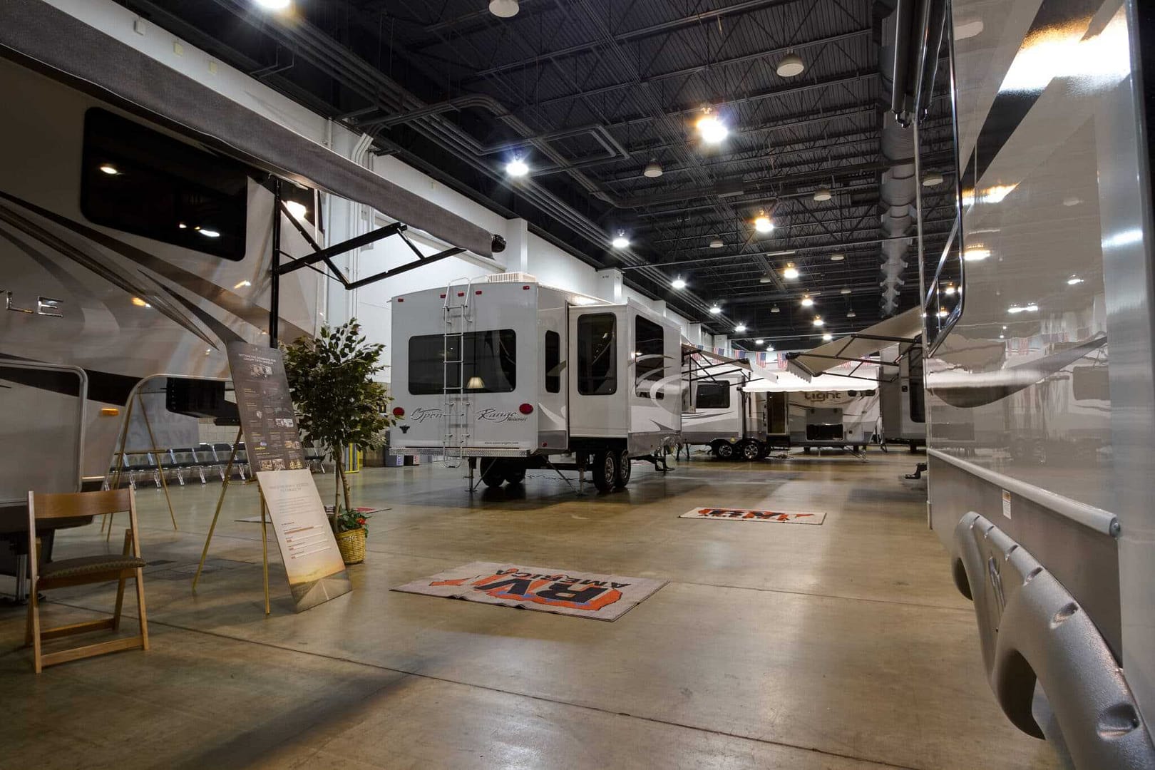 An rv showroom with many rvs in it.