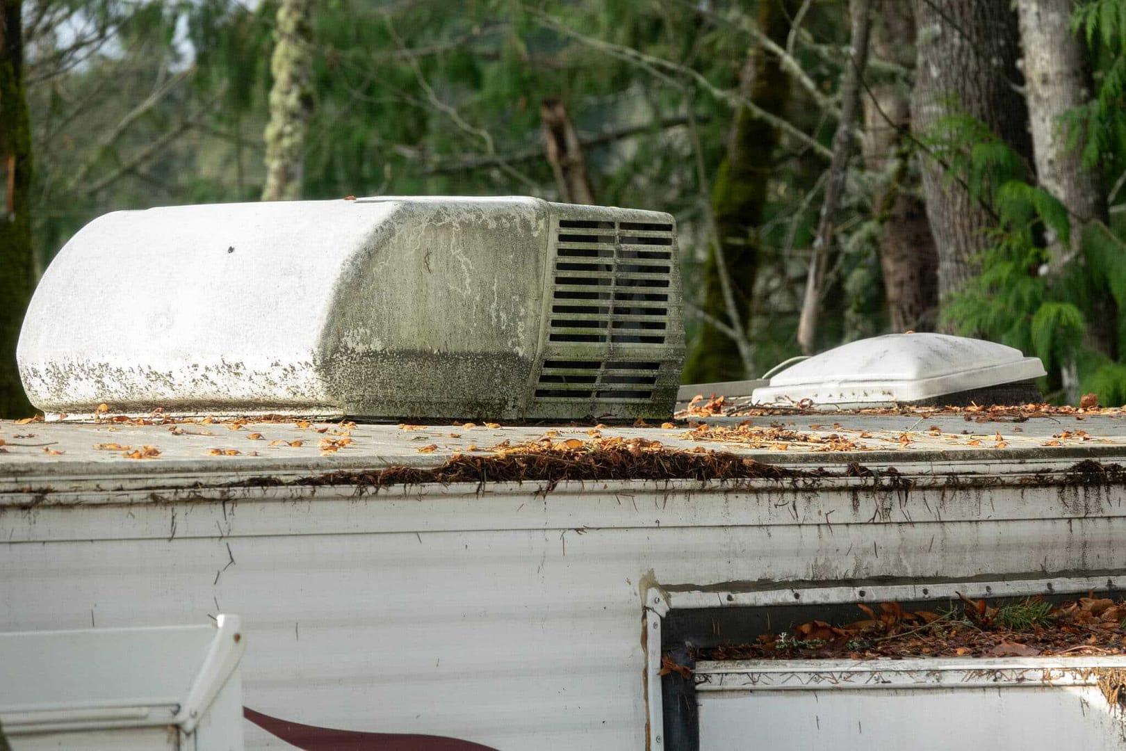 An rv air conditioner sits on top of a roof in a Luxury RV Park.