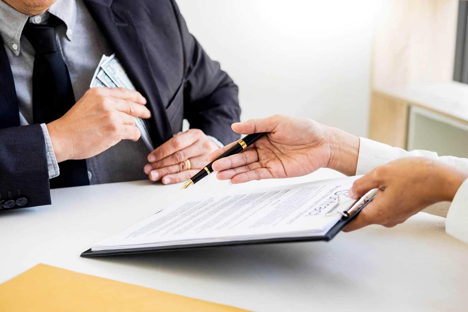 Two people signing a document at a desk in a tourist accommodation establishment in Teesdale, amidst the visitor surge.