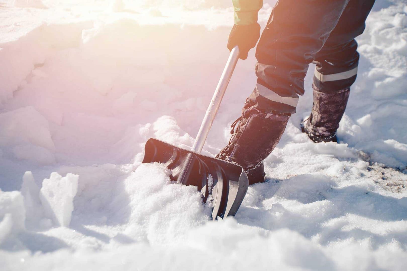 A person diligently shovels snow during a Winter Storm.