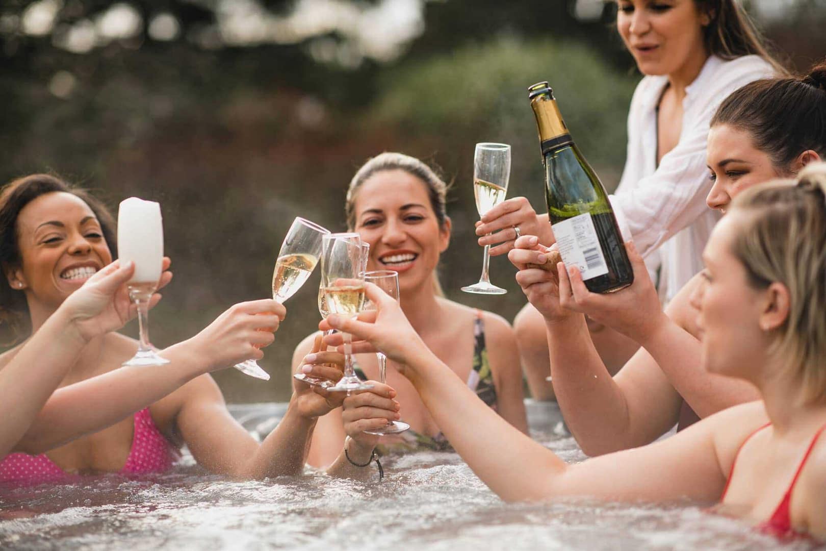 A group of women toasting champagne in a UK Glamping Pod.