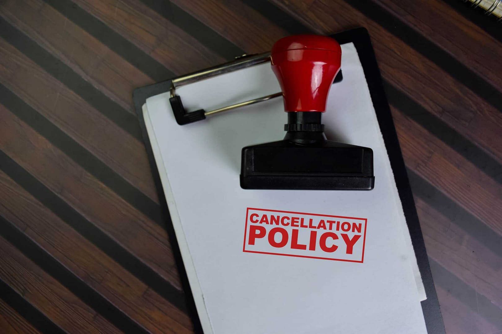 A red rubber stamp with the word cancellation policy on it.