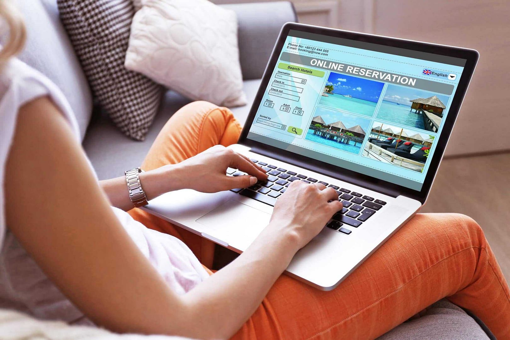 A woman using a laptop on a couch.