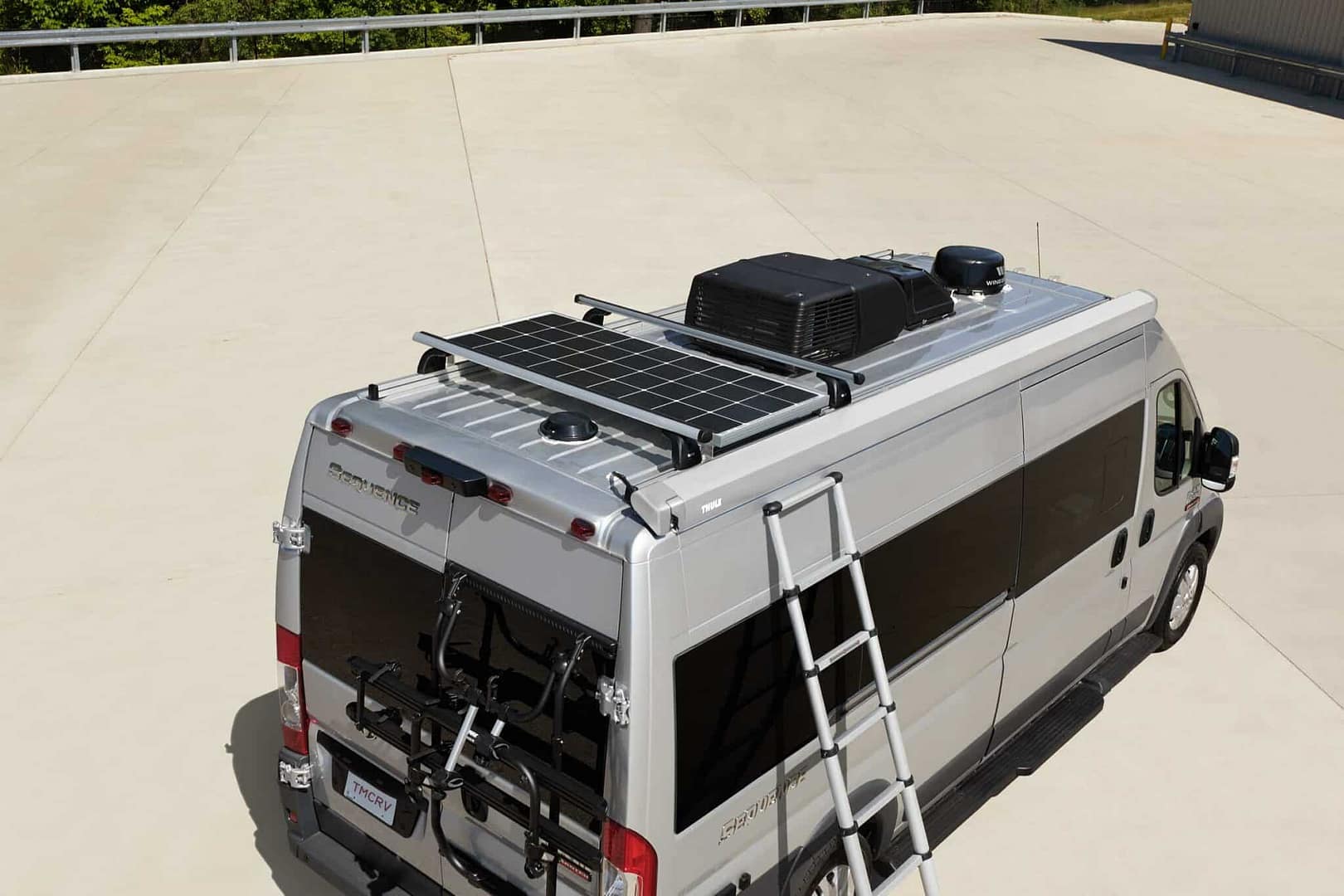 A compact van with a solar panel on the roof, perfect for cozy winter camping.