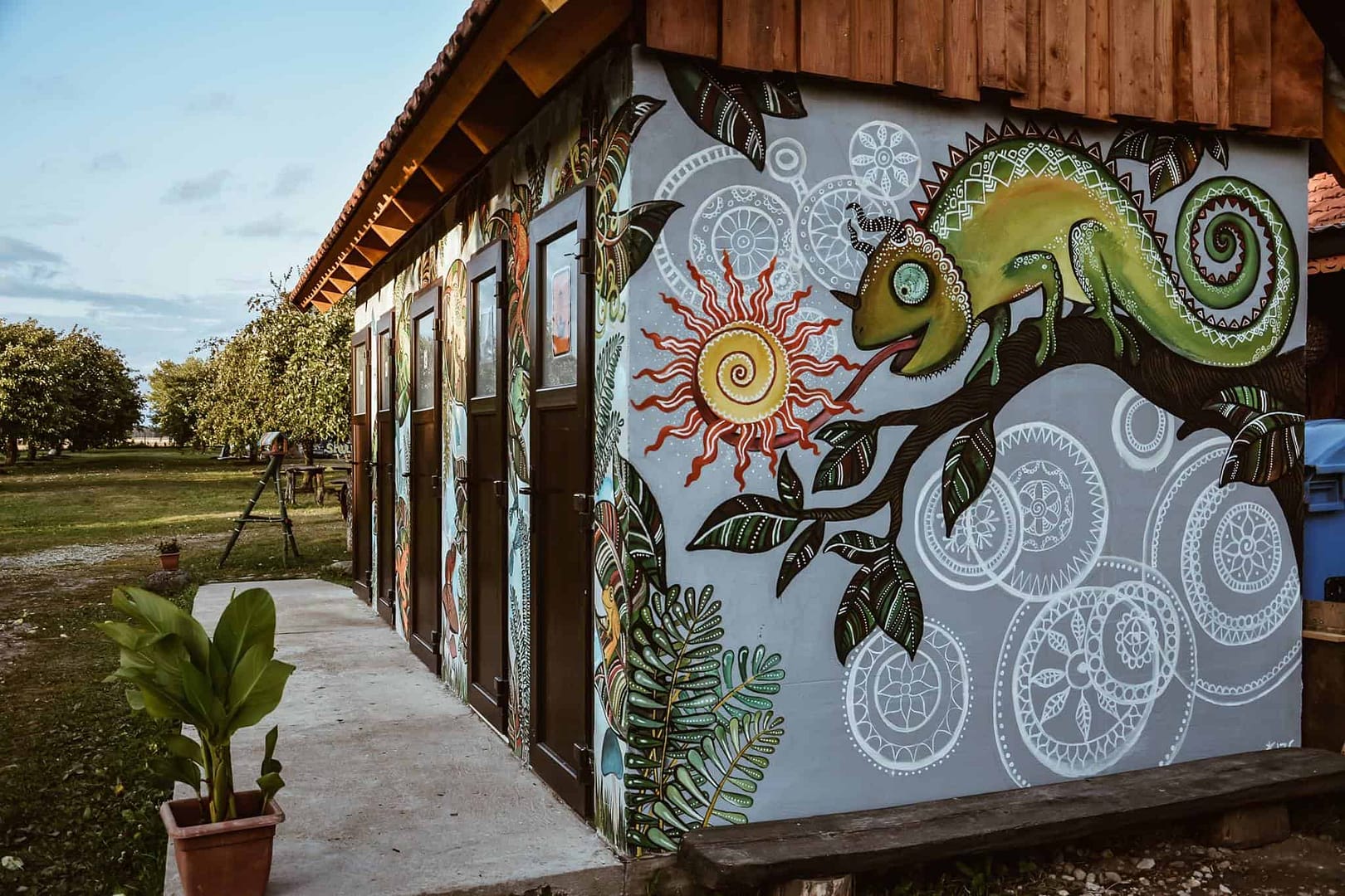 A building adorned with a vibrant mural, showcasing the hip culture of Sunny Nights Camping.