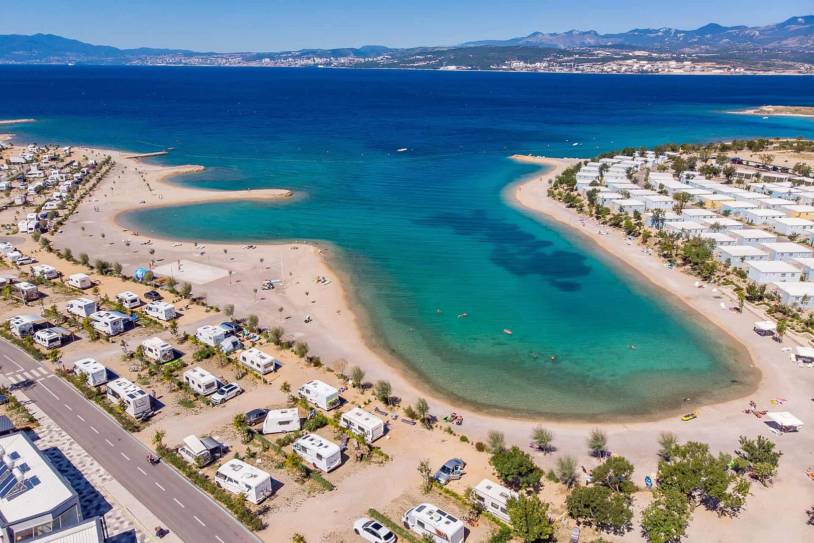 Camp Omisalj, a Croatian hospitality gem located on Krk Island, offers an unbeatable experience of an awe-inspiring aerial view of the RV park nestled near the mesmerizing sea