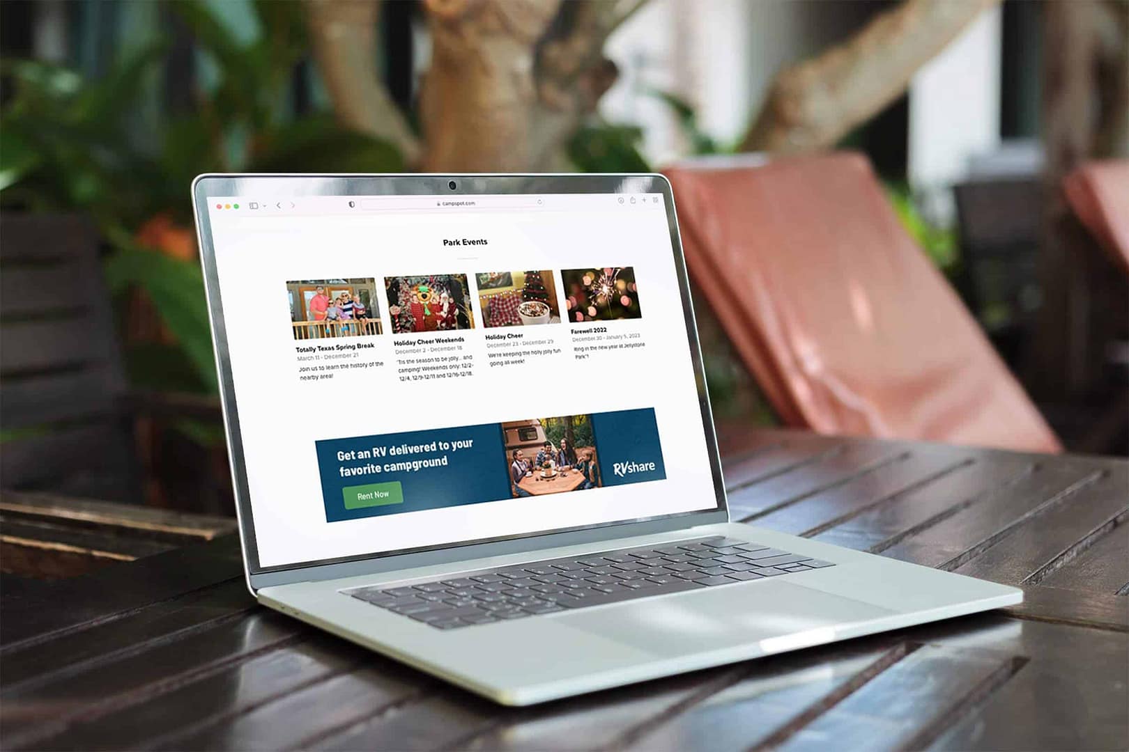 A laptop is sitting on a wooden table, displaying revenue potential for private campground owners through the Campspot Accelerator.