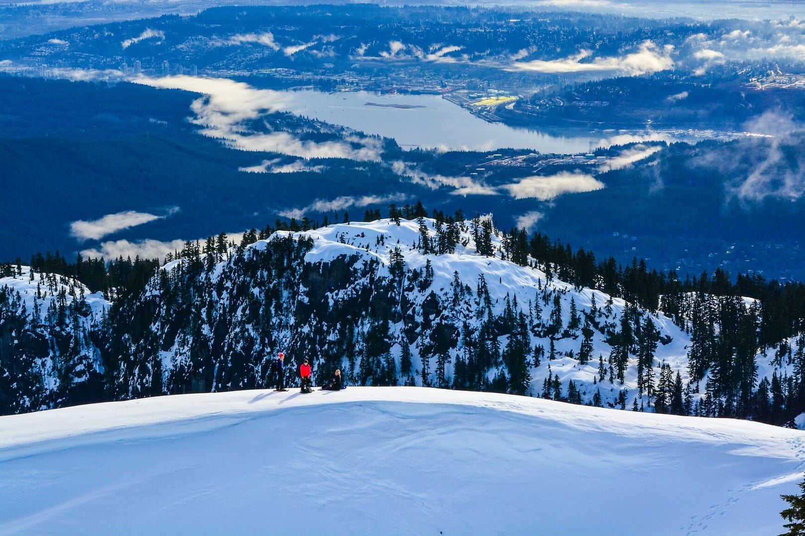 A group of people skiing down Mount Seymour.