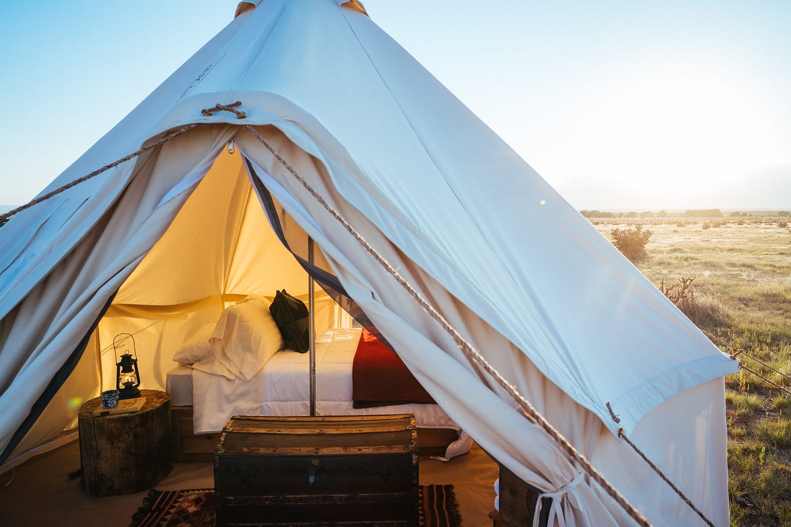 A luxury white tent in the middle of the desert.