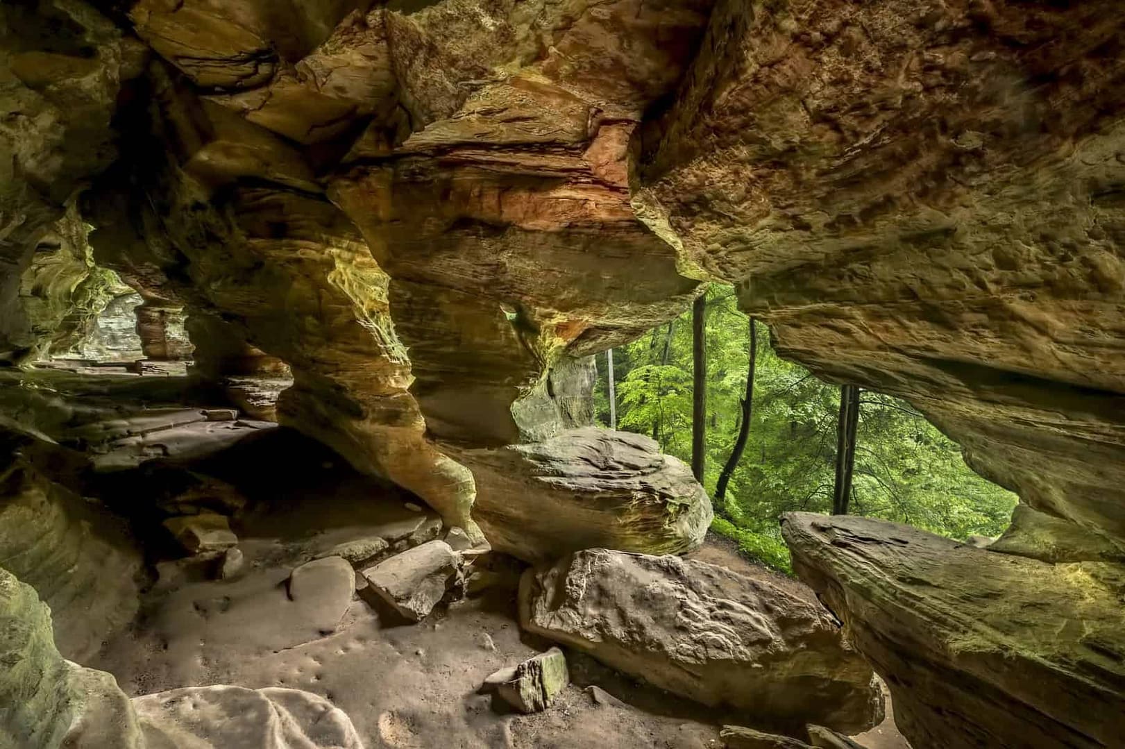 Racine Campground, a business spotlight honoree, offers adventurers the opportunity to explore a stunning cave surrounded by majestic trees in the background.