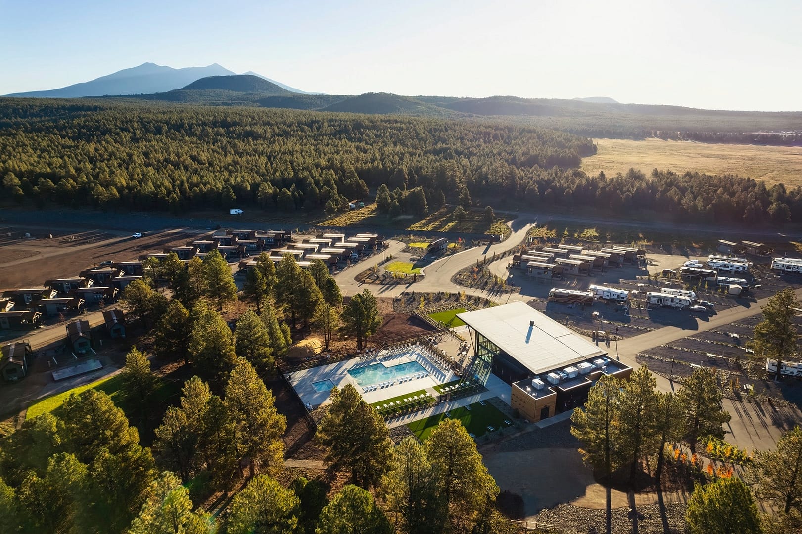 A picturesque RV park nestled in a forest, offering a delightful blend of nature and relaxation.