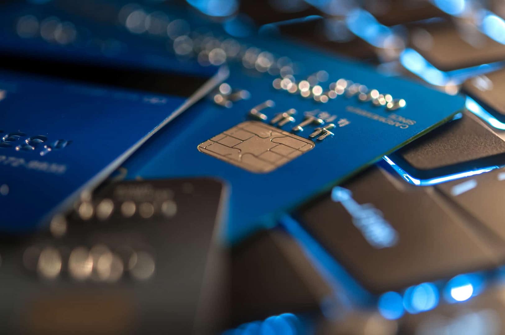 A close up of several credit cards on a keyboard in Houston.