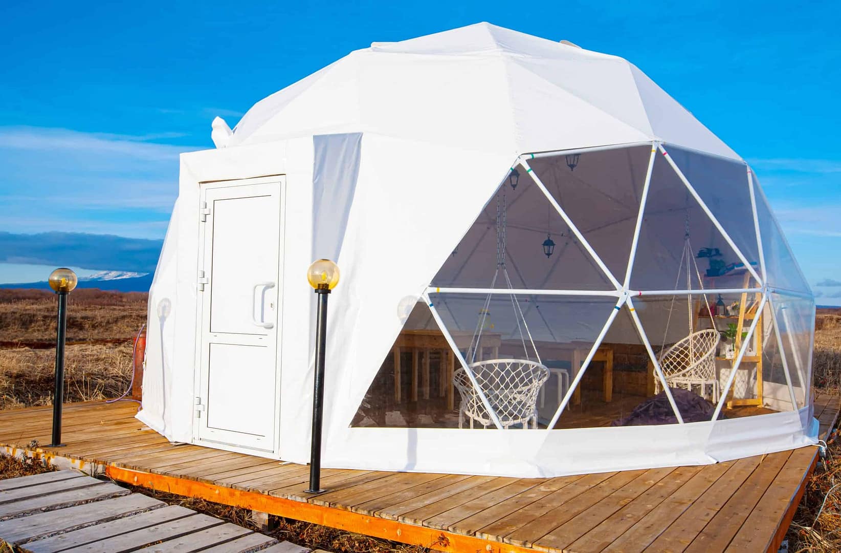 A white dome nestled on top of a wooden deck, offering a unique glamping site experience with stunning views of the Shawangunk Ridge.