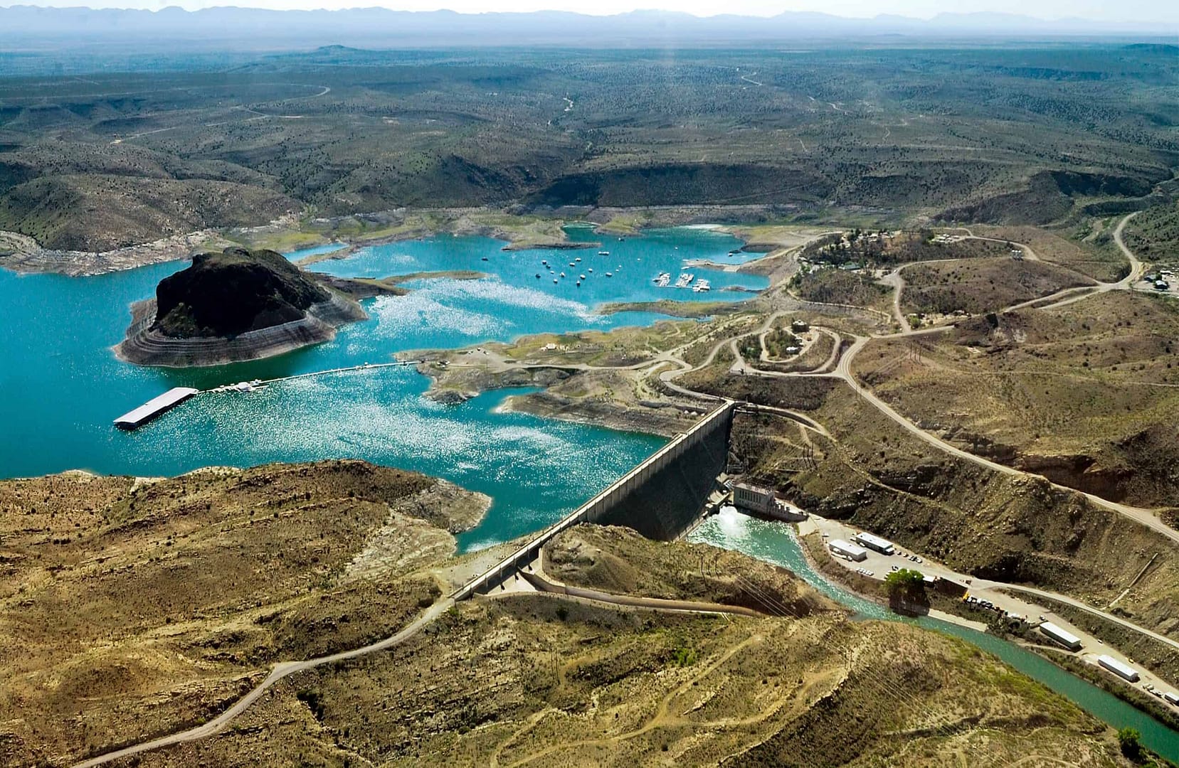 An outdoor aerial view showcasing a dam in the middle of a lake.