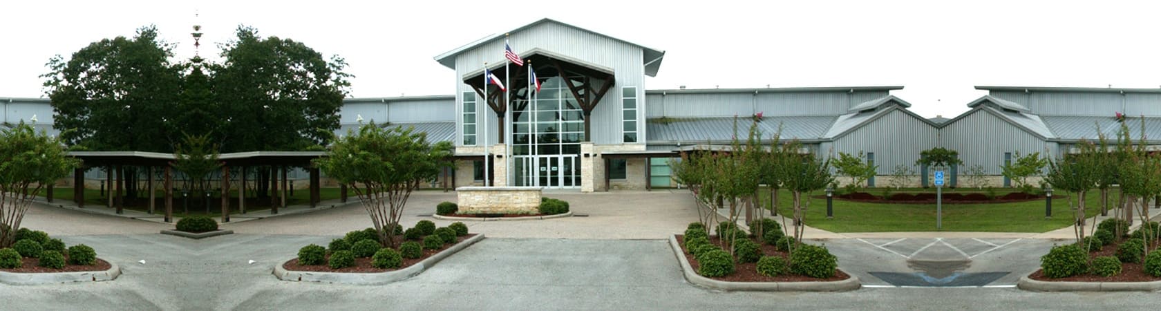 A building with trees in front of it, showcasing the new bigger location for the TACO Meeting and Trade Show.