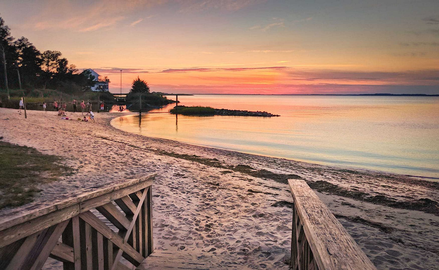 A wooden walkway leading to a beach at sunset in Virginia Campground.