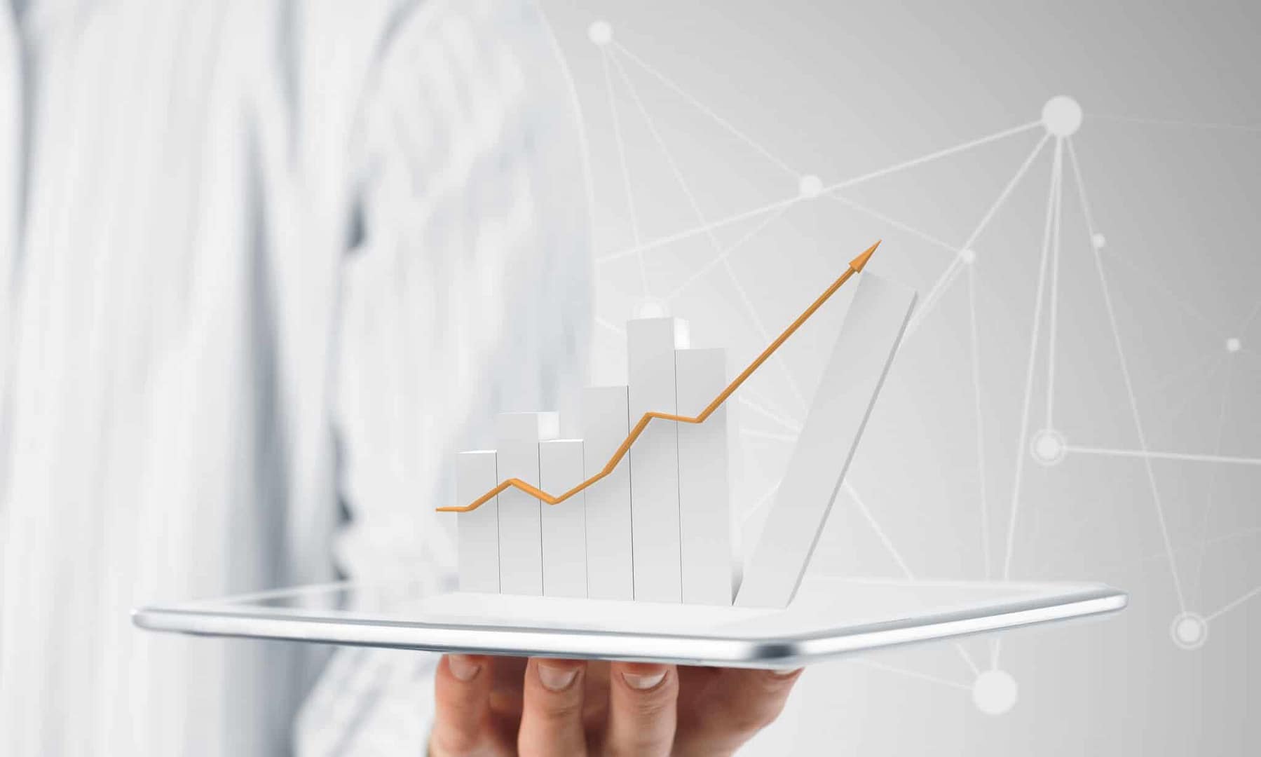 A man holding a tablet with a graph on it.