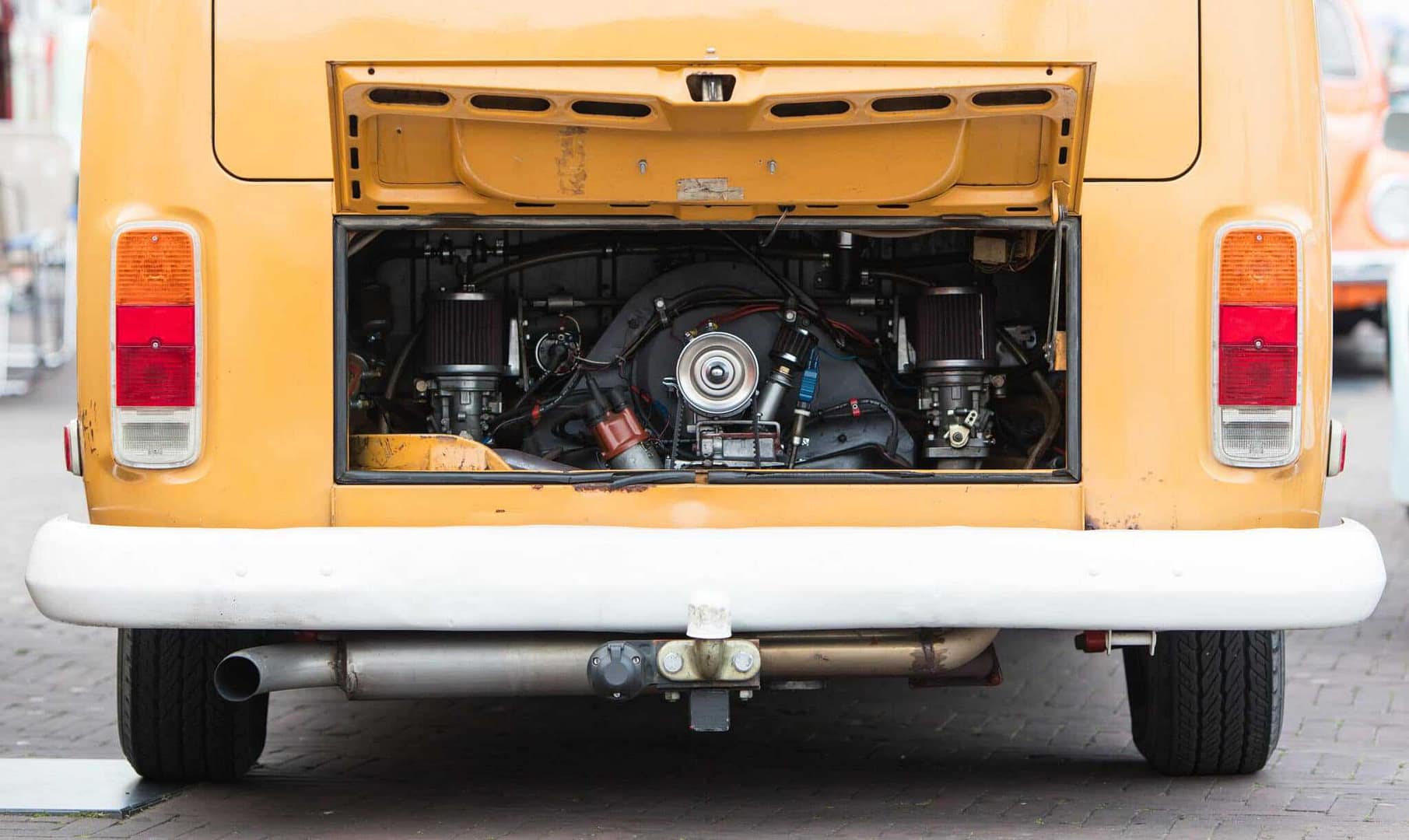 A yellow van with an engine in the back that abides by CARB regulations for Small Off-Road Engine.