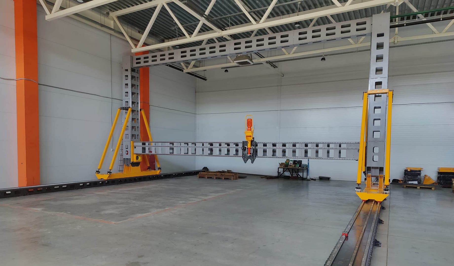 A large warehouse with a sustainable construction crane utilizing AC3D for 3D printing technology.