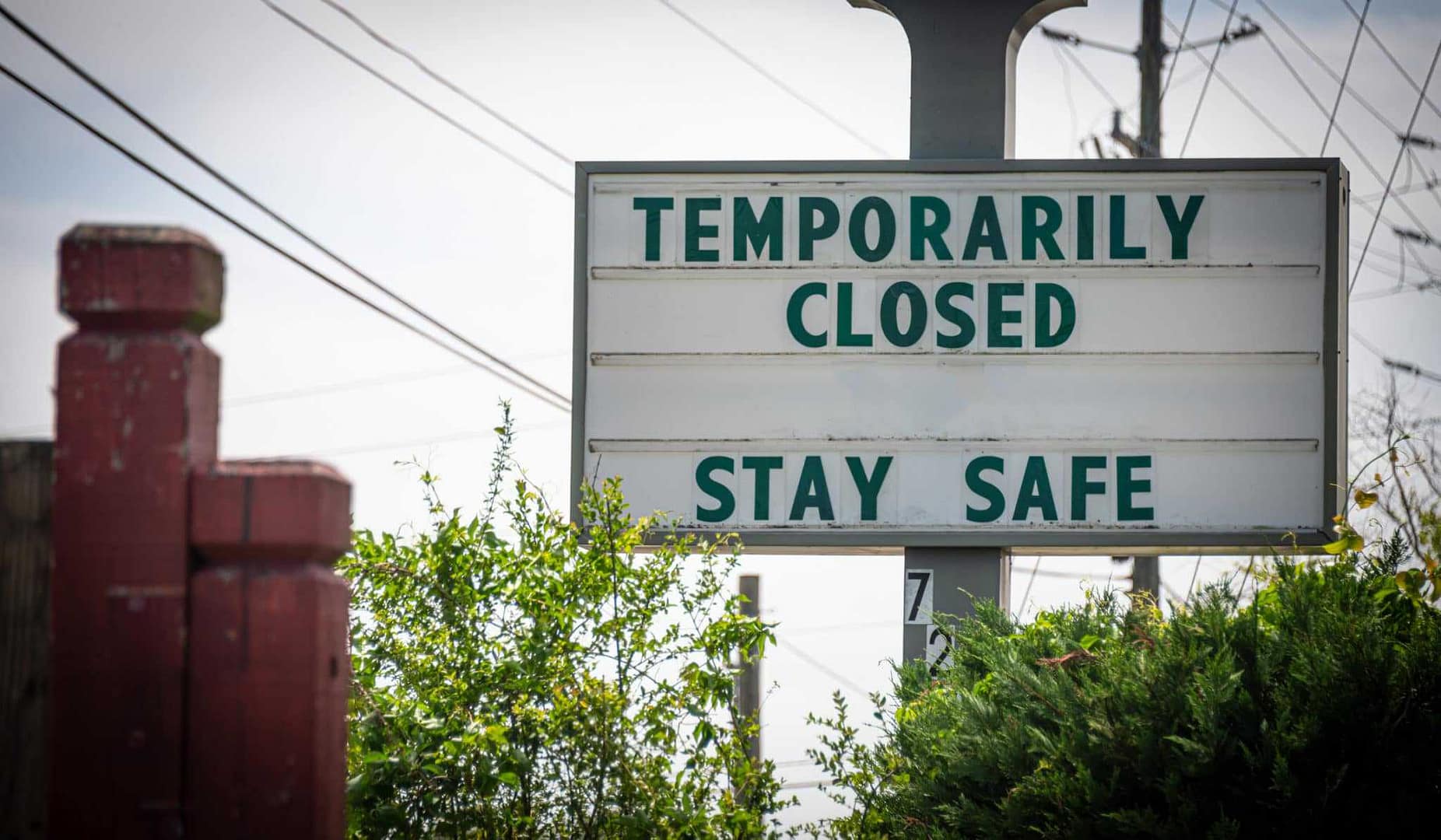A sign that says temporarily closed stay safe.