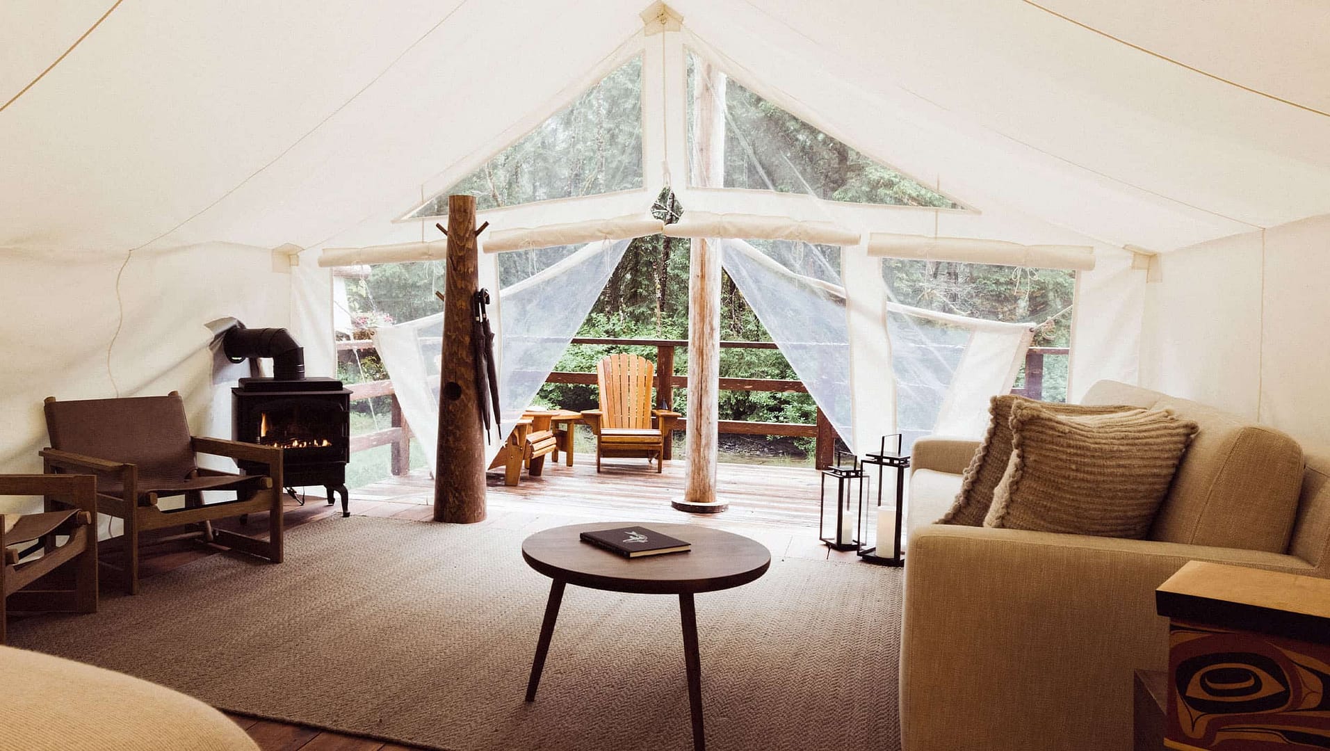 A luxurious escape inside the Clayoquot Wilderness Lodge, nestled in Canada's pristine wilderness. The room features a comfortable couch and chairs for ultimate relaxation.