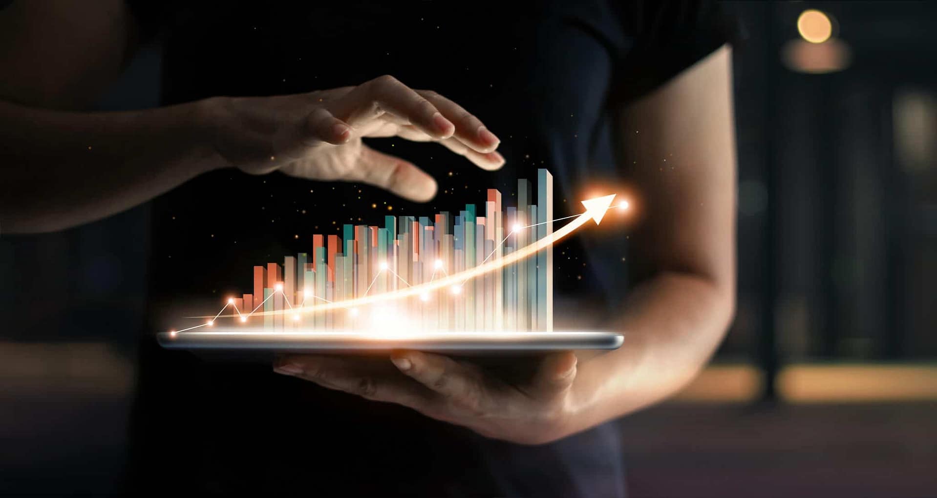 A person holding a tablet displaying a graph representing the impact of the pandemic on the German economy.