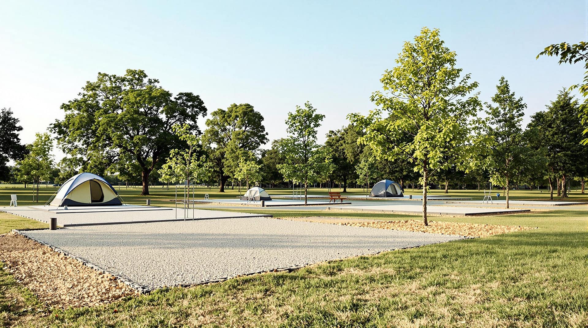 A newly redesigned campground showcasing leveled tent sites with gravel pads and mature trees in the background under a clear sky, highlighting the organized layout and inviting natural surroundings.