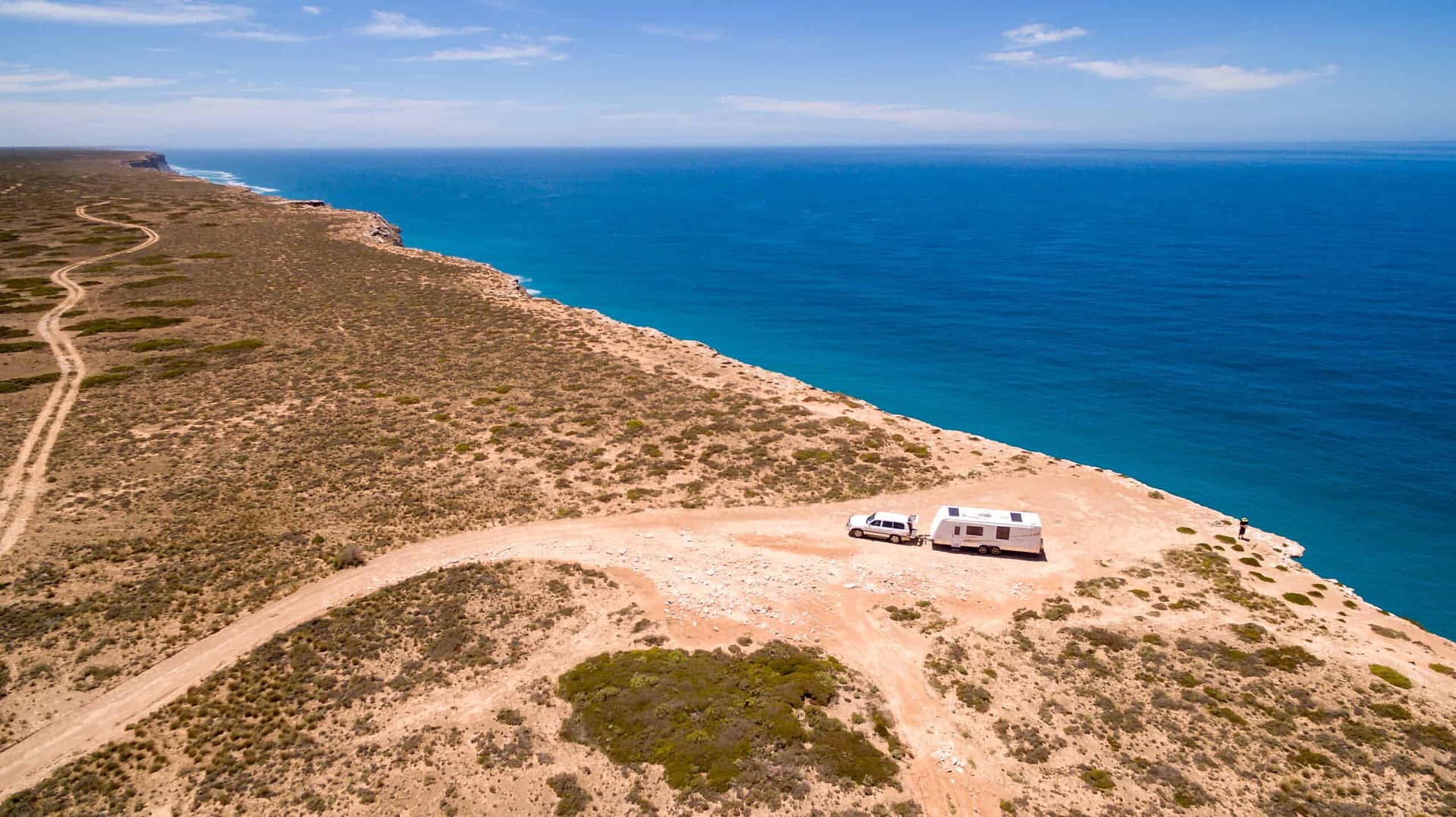 An aerial view of an rv parked near the ocean.