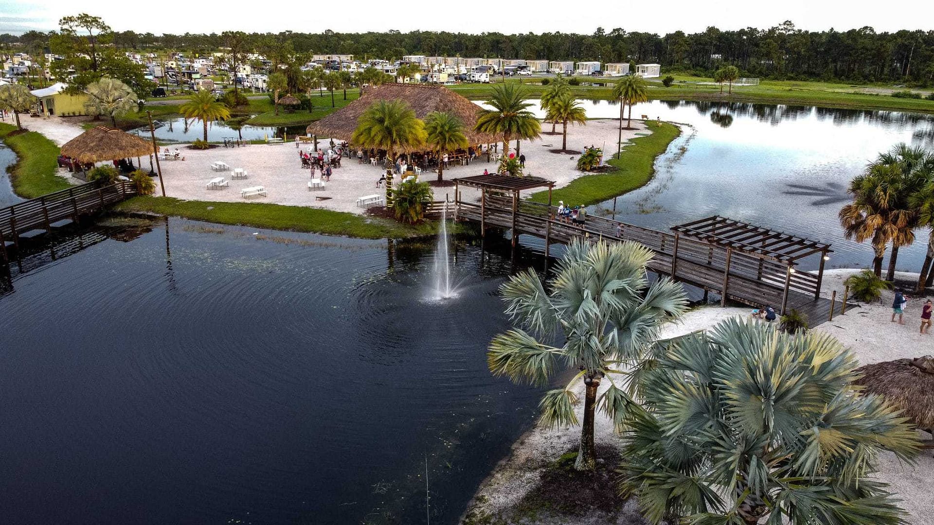 An aerial view of a pond with palm trees, winner of the LUXlife Travel & Tourism 2022 Award.