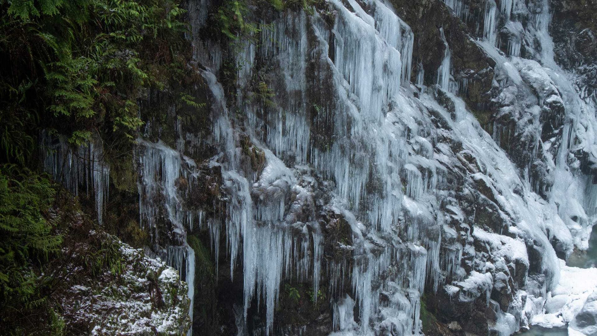 A waterfall with icicles hanging from it.