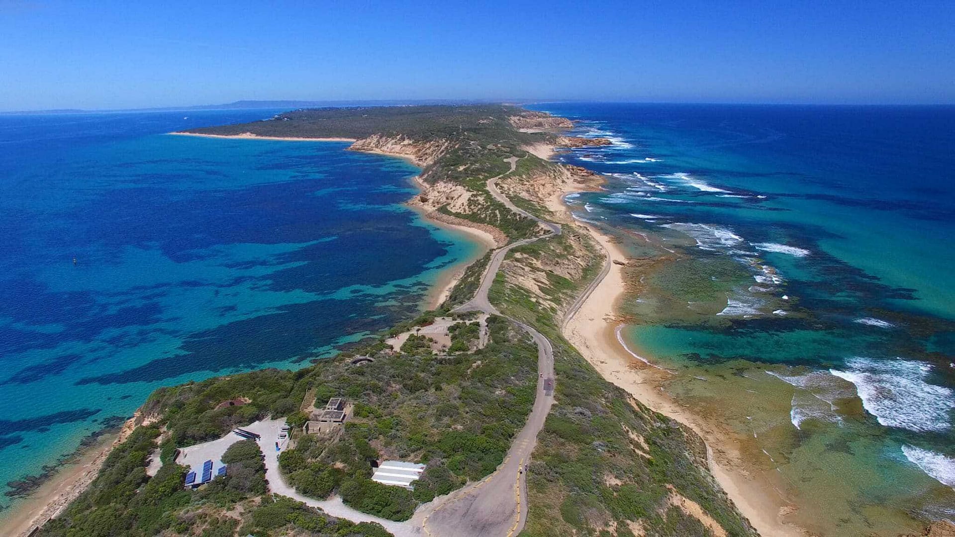 An aerial view of Point Nepean National Park in Australia, featuring a stunning beach and the vast ocean.