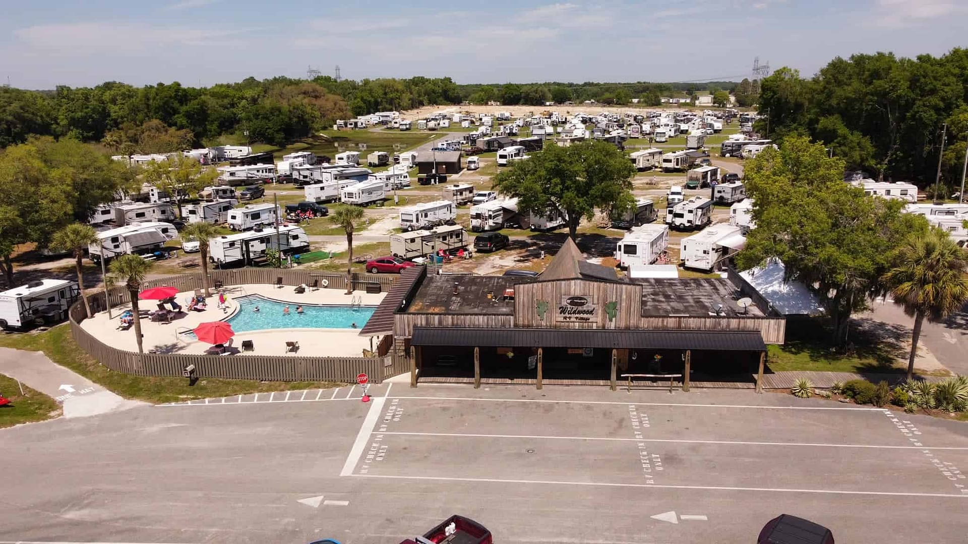 An aerial view of Wildwood RV Village, a sprawling rv park with lots of parked rvs.