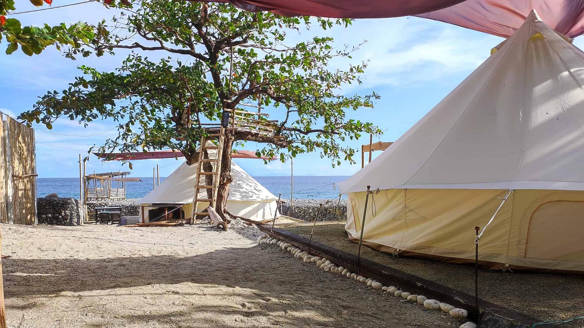 A group of teepee tents on the seafront beach camp in the Philippines.
