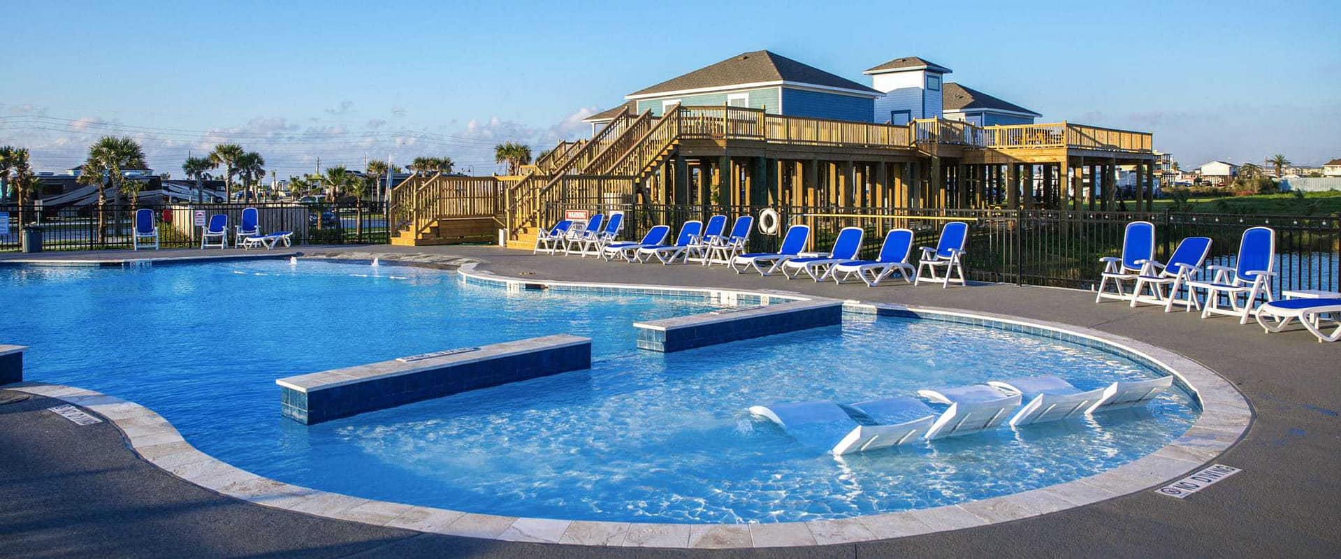 Telos Capital presents an outdoor pool with lounge chairs and a deck, offering a serene space for relaxation and enjoyment.