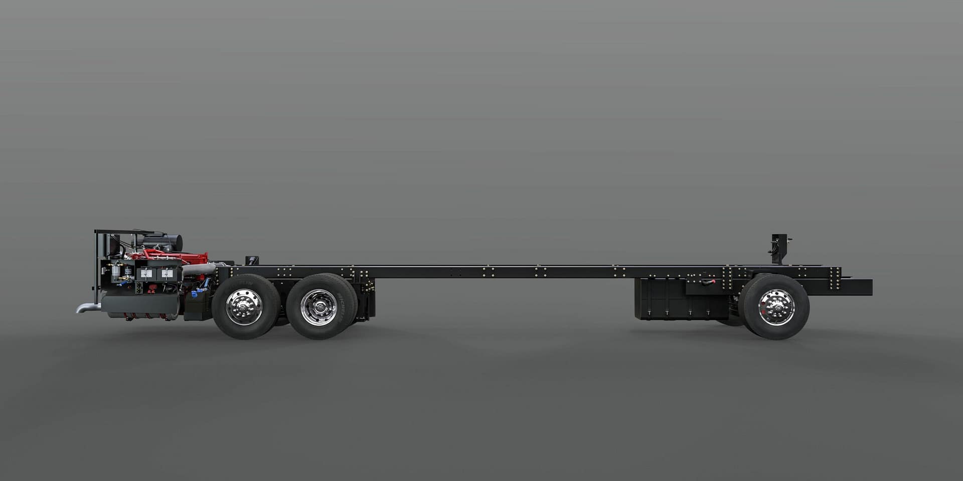 A Spartan RV Chassis hauling a flatbed trailer on a gray background.