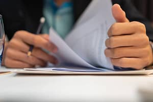 A person is holding a document and giving a thumbs up to support the Buy American Legion Campground.