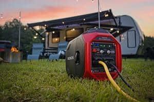 A Honda EU3200i generator in the grass next to an RV.