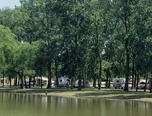 Camping at Wakonda State Park with a lake and trees in the background.