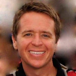 A man in a red shirt smiling for the camera during the December 7th, 2022 MC Fireside Chats event.