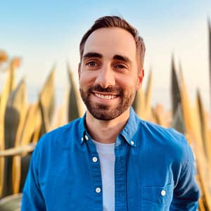 A man in a blue shirt standing in front of cactus during MC Fireside Chats on January 11, 2023.