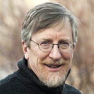 A man with glasses and a beard smiling for the camera at the October 6th MC Fireside Chats event in 2021.