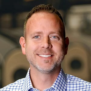 MC Fireside Chats on August 30th feature a man in a blue checkered shirt smiling.
