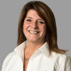 A woman in a white shirt smiling during the MC Fireside Chats on January 17th, 2024.