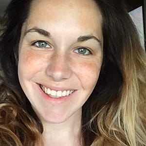 A woman with long hair smiling for the camera during the MC Fireside Chats on January 17th, 2024.