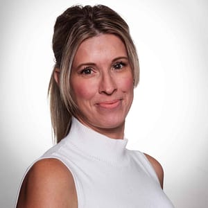 A woman in a white top posing for a photo during the MC Fireside Chats on March 13th, 2024.