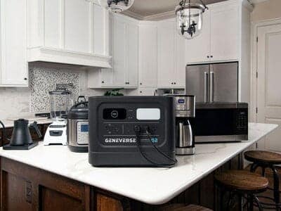 A kitchen island with a solar generator and coffee maker.